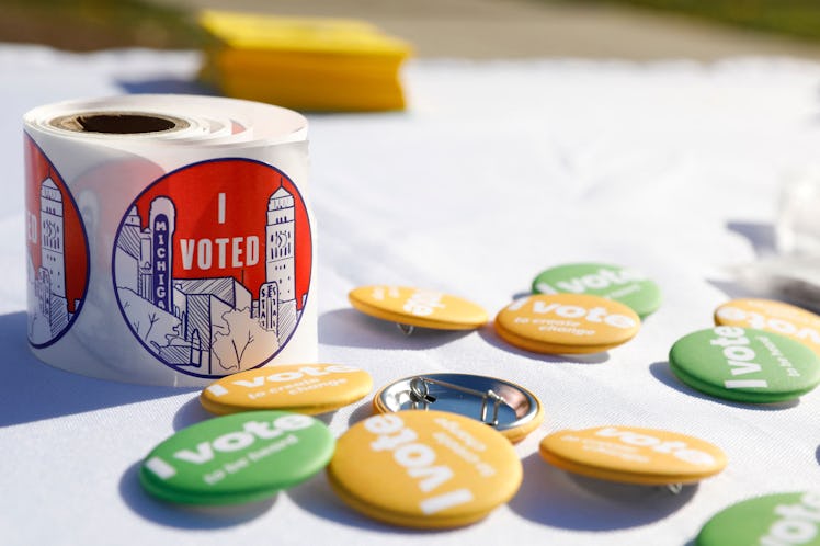 "I voted" stickers and buttons are displayed on a table as people cast their early ballots for the 2...