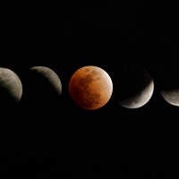TOPSHOT - The moon enters and emerges from the earth's shadow during a total eclipse of the moon on ...