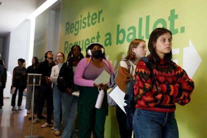 People line up to cast their early ballots for the 2022 general election at the Ann Arbor, Michigan ...