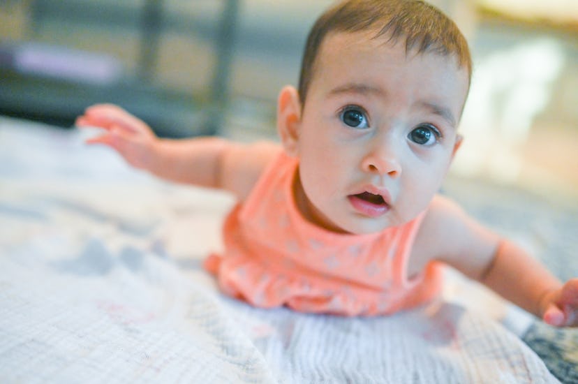 baby doing tummy time in an article about when to start tummy time