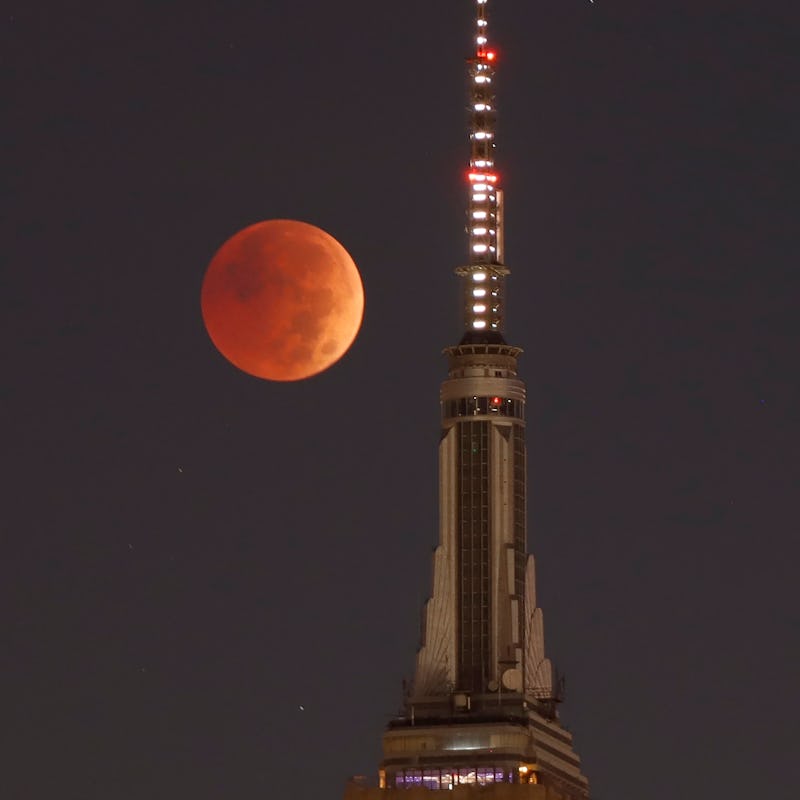 NEW YORK, NY - NOVEMBER 8: The blood-red full Beaver Moon passes behind the Empire State Building du...