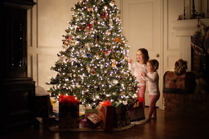 Young girls decorating Christmas tree at night can christmas tree catch fire?