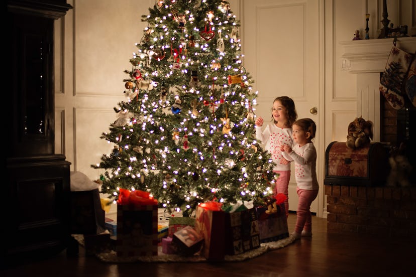 Young girls decorating Christmas tree at night can christmas tree catch fire?