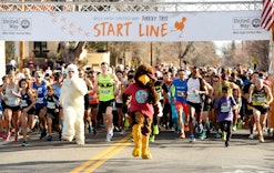 A turkey mascot leads runners in an annual turkey trot race, where people may want to post turkey tr...