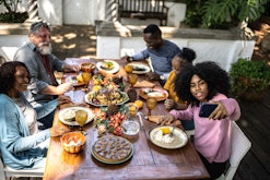 a family having thanksgiving dinner in a round up of thanksgiving instagram captions