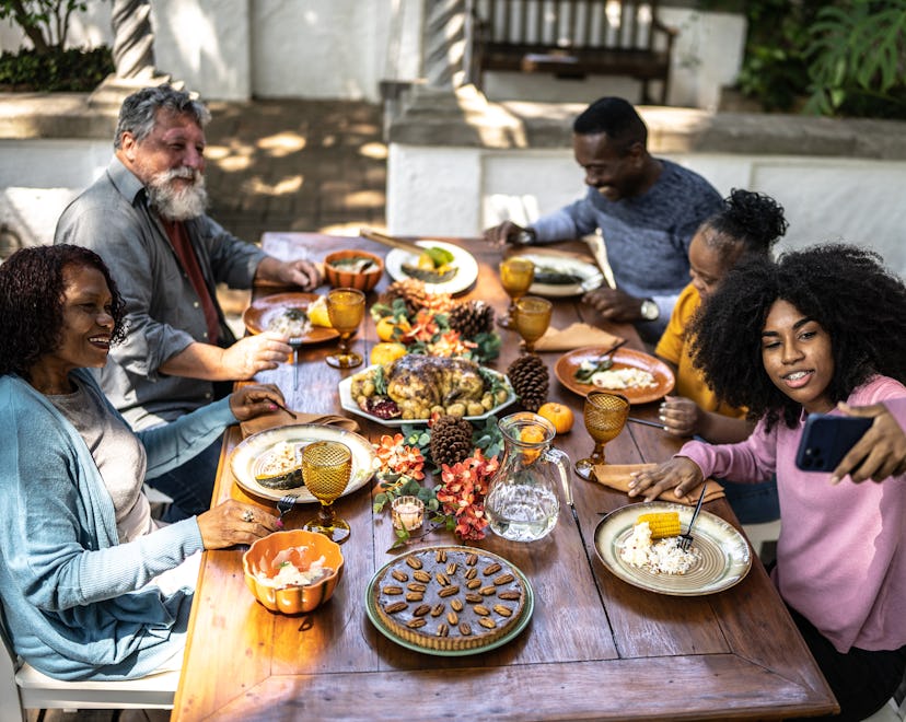 a family having thanksgiving dinner in a round up of thanksgiving instagram captions