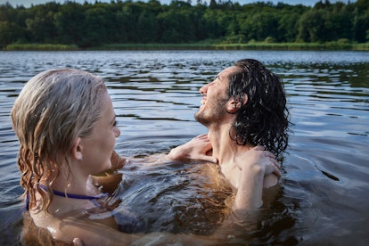 Young couple in a lake to represent water signs, who are intuitive and compassionate.