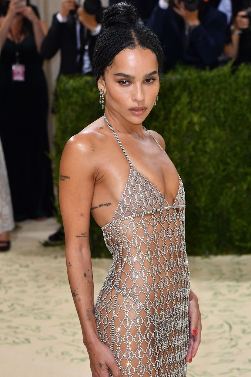 Zoe Kravitz at the Met Gala in a silver, bedazzled, sheer dress and an up do 