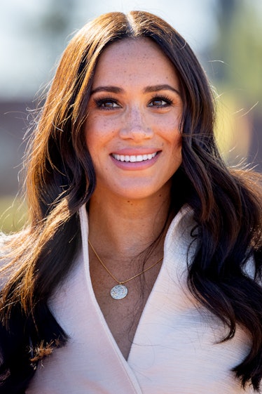 Megan Markle smiling with loose curls