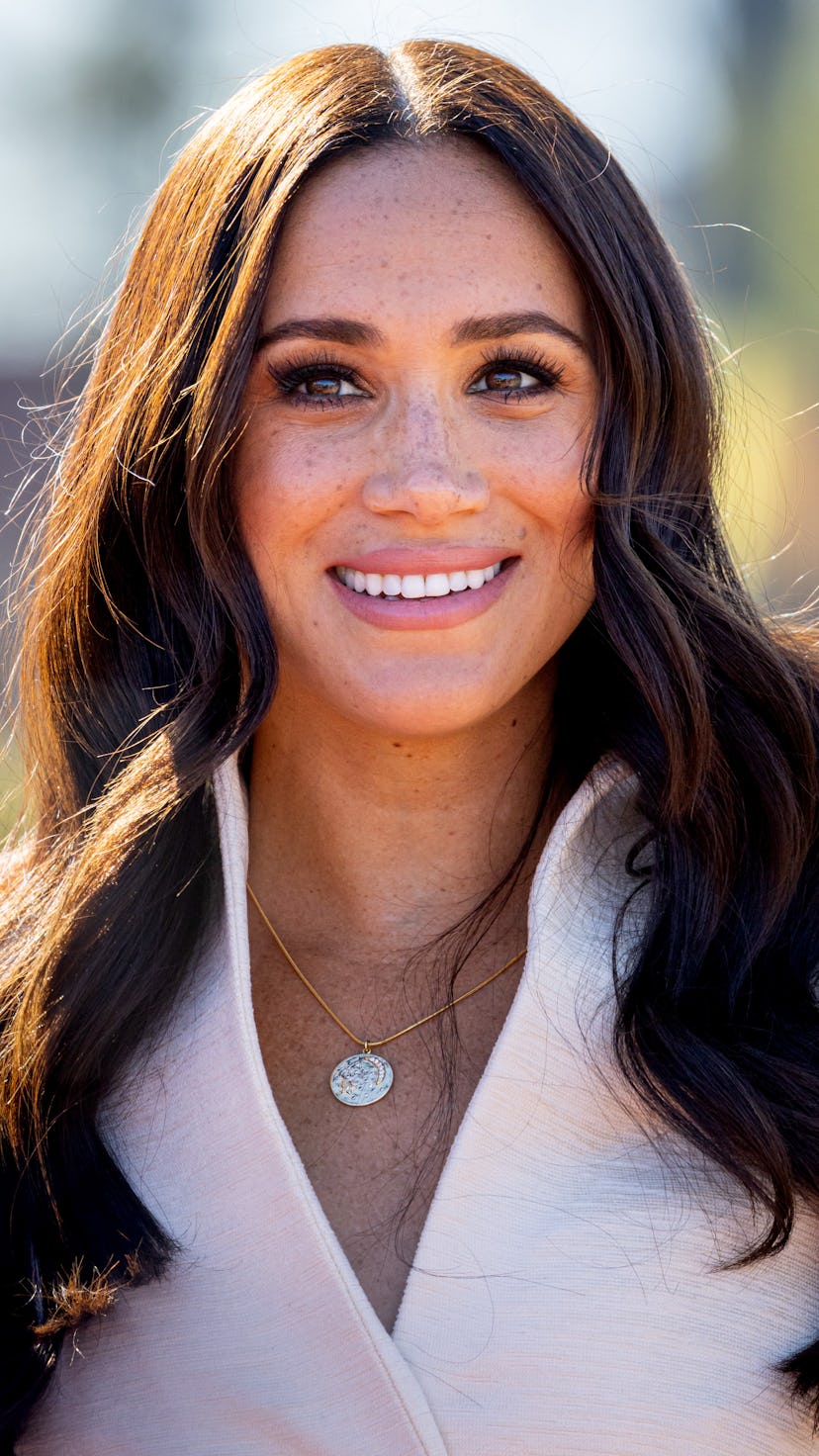 Megan Markle smiling with loose curls