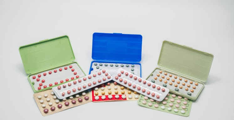 Pile of contraceptive pills in blister pack. Birth control pills. Family planning. Woman hormones ta...