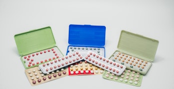 Pile of contraceptive pills in blister pack. Birth control pills. Family planning. Woman hormones ta...