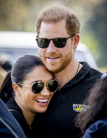 Duke and Duchess of Sussex, Prince Harry (R) and his wife, Meghan Markle embrace at The Invictus Gam...