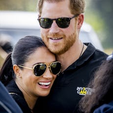 Duke and Duchess of Sussex, Prince Harry (R) and his wife, Meghan Markle embrace at The Invictus Gam...