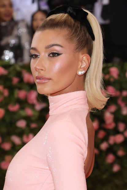 Hailey Bieber's hair bow ribbon ponytail at 2019 Met Gala celebrating "Camp: Notes on Fashion" at Th...