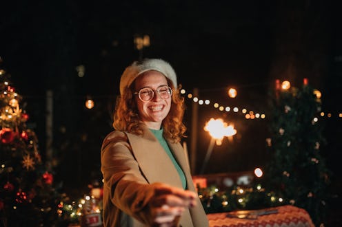 Lovely young woman with red curly hair feeling happy and excited about Christmas.