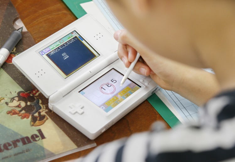 To go with "Entertainment-Japan-game-education" by Karyn POUPEE A girl uses a Nintendo DS Lite to st...