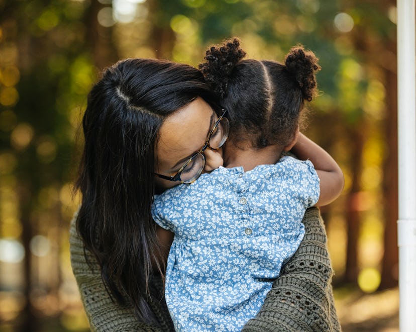 a mom and toddler snuggling in an article about tantrums after taking pacifier away