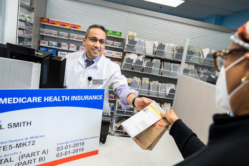 A CVS pharmacist helps a customer. CVS pharmacies will be closed on Christmas Day, for the most part...