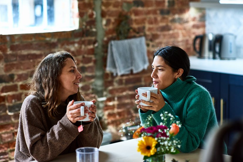 Female friends sitting in cafe with mug of coffee, am i annoying you?