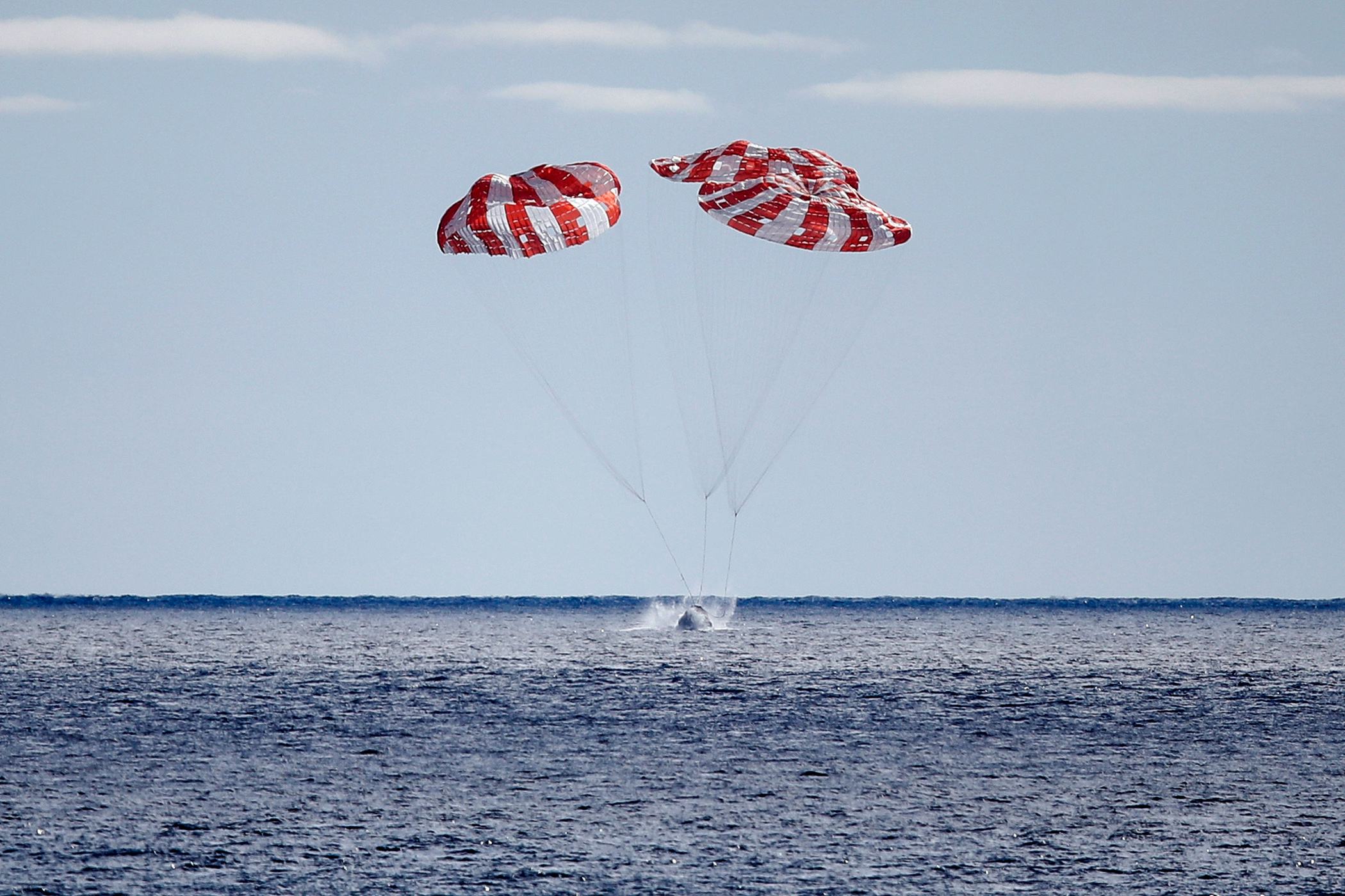 AT SEA, PACIFIC OCEAN - DECEMBER 11: NASA's Orion Capsule splashes down after a successful uncrewed ...