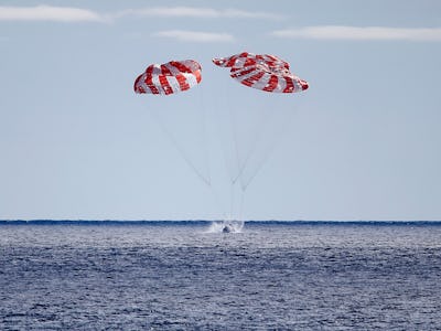 AT SEA, PACIFIC OCEAN - DECEMBER 11: NASA's Orion Capsule splashes down after a successful uncrewed ...