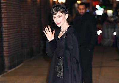 Lily Collins wearing a black outfit on her press tour for Emily in Paris.
