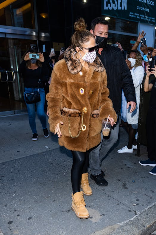 Jennifer Lopez wearing a fuzzy shearling coat from Coach.