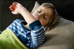 Sick little boy covering his mouth while coughing, how to stop persistent cough in children