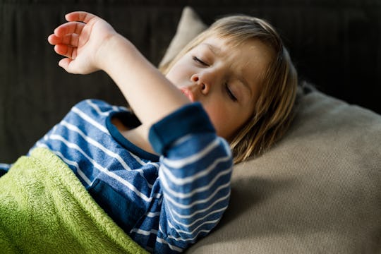 Sick little boy covering his mouth while coughing, how to stop persistent cough in children