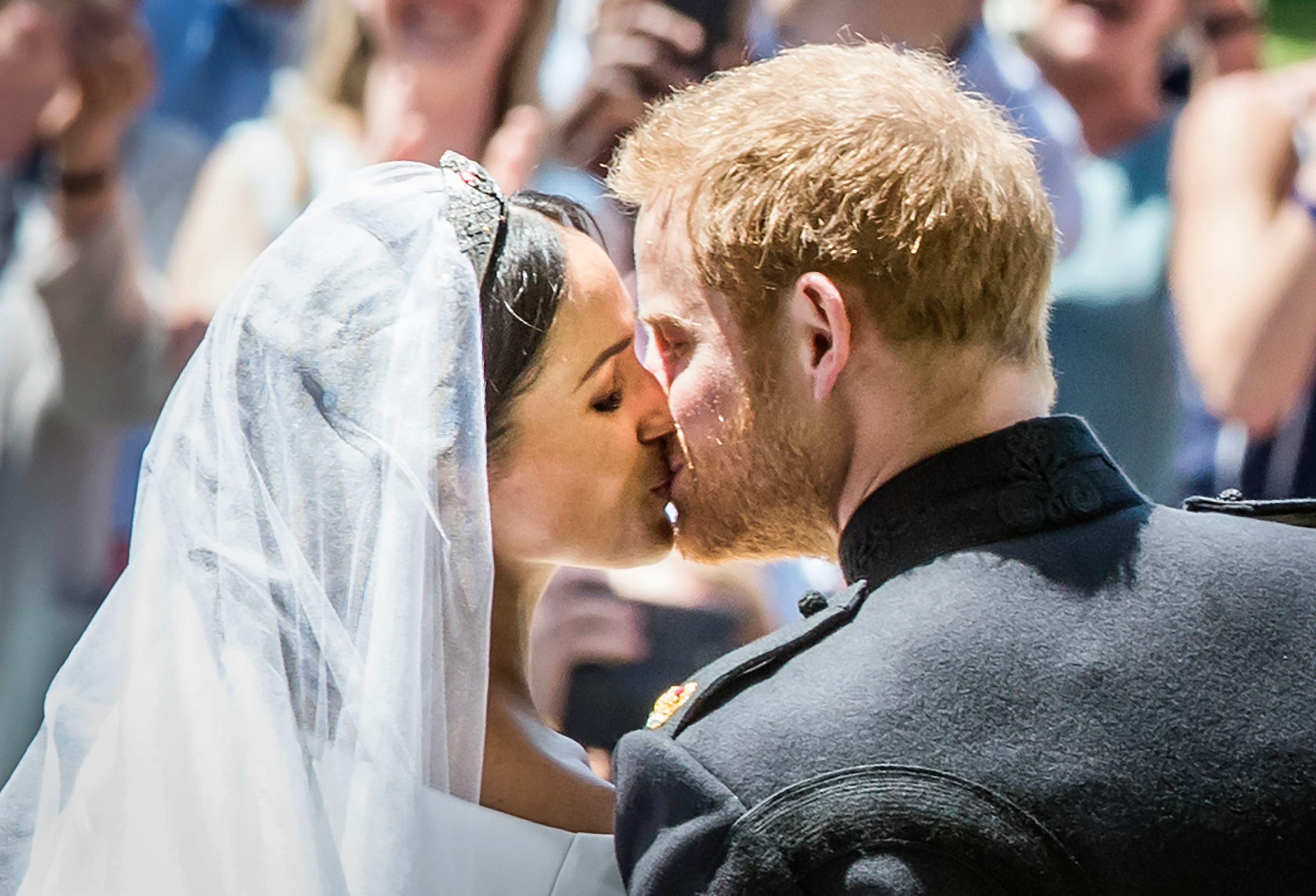 TOPSHOT - Britain&rsquo;s Prince Harry, Duke of Sussex kisses his wife Meghan, Duchess of Sussex as they l&hellip;