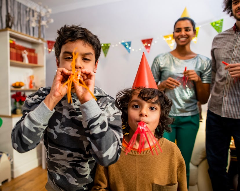 New Year's Eve party celebration with kids, a mixed-age, multi-ethnic family