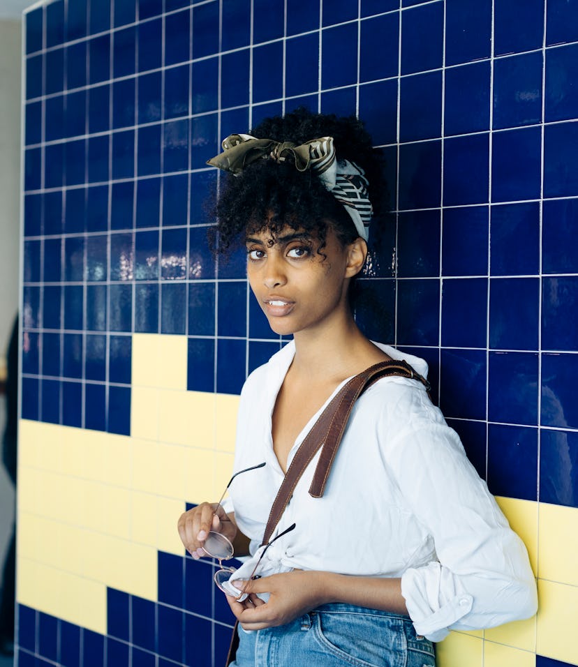 Woman wearing a silk hair accessory to protect her curly hair.
