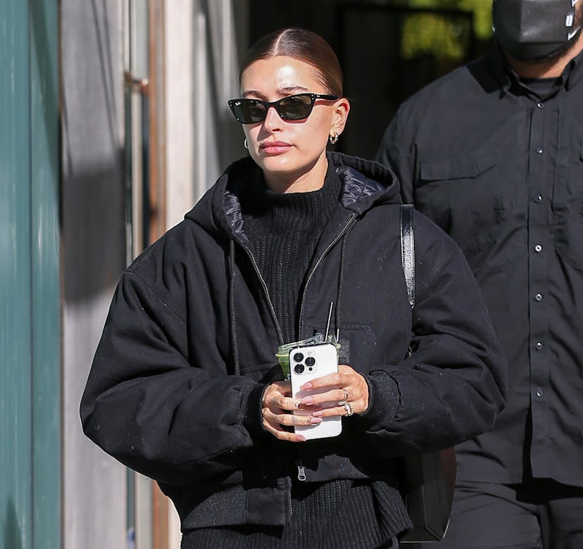Hailey Bieber wearing a black puffer jacket.