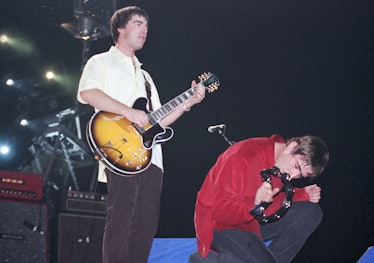 Noel Gallagher and Liam Gallagher of Oasis performs on stage at Earls Court, London, Septmebr 1997. ...