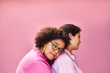 two young women embrace in front of a pink wall, as they consider how their december 26, 2022 weekly...