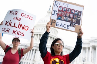 UNITED STATES - MAY 26: A demonstrator holds a sign depicting children killed at the Robb Elementary...