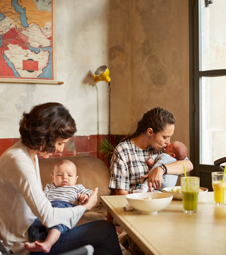 Happy mother with their babies sitting at table in restaurant When It's Safe To Bring Your Newborn T...