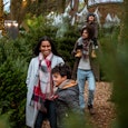 A multi-ethnic family at a Christmas tree farm together in Newcastle-Upon-Tyne. The eldest son is pu...