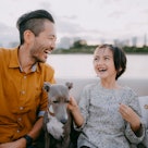 Japanese father and young daughter having a good time on boat with dog, Tokyo Bay, Japan
