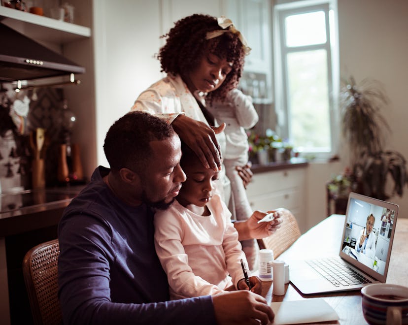 Close up of a young family consulting with their doctor in an article about children's tylenol short...