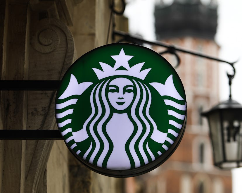 Starbucks Coffee logo hanging outside of a coffee shop in an article about Starbucks' New Year's Eve...