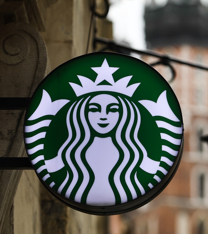 Starbucks Coffee logo hanging outside of a coffee shop in an article about Starbucks' New Year's Eve...