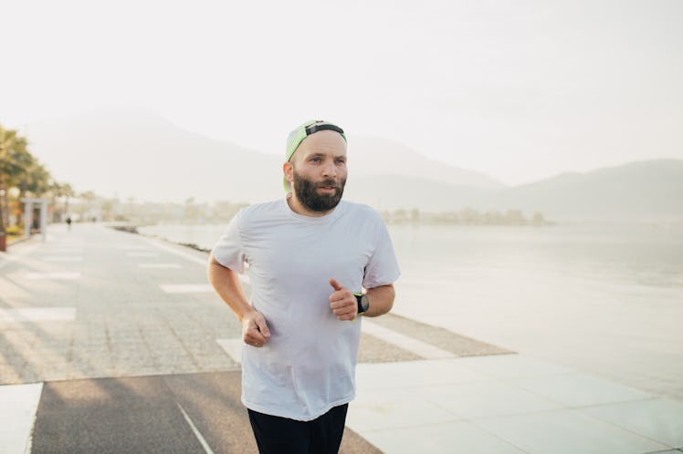 A man does a running workout outside.