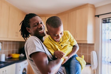 Cropped shot of an affectionate young single father playing with his son while cleaning in their kit...