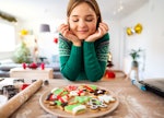 A woman decorating Christmas cookies needs cookie captions for Instagram.