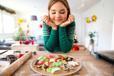 A woman decorating Christmas cookies needs cookie captions for Instagram.