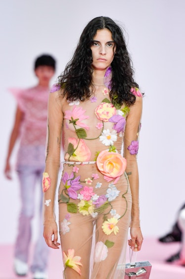 A model walks the runway during the Acne Studio Ready to Wear Spring/Summer 2023 fashion show wearin...