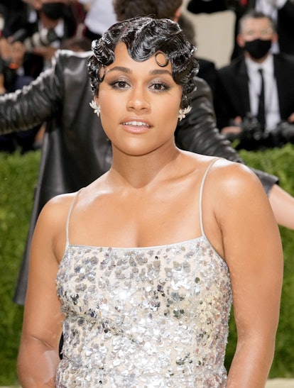 Ariana DeBose attends The 2021 Met Gala with a black finger wave pixie and soft smoky eye makeup tha...