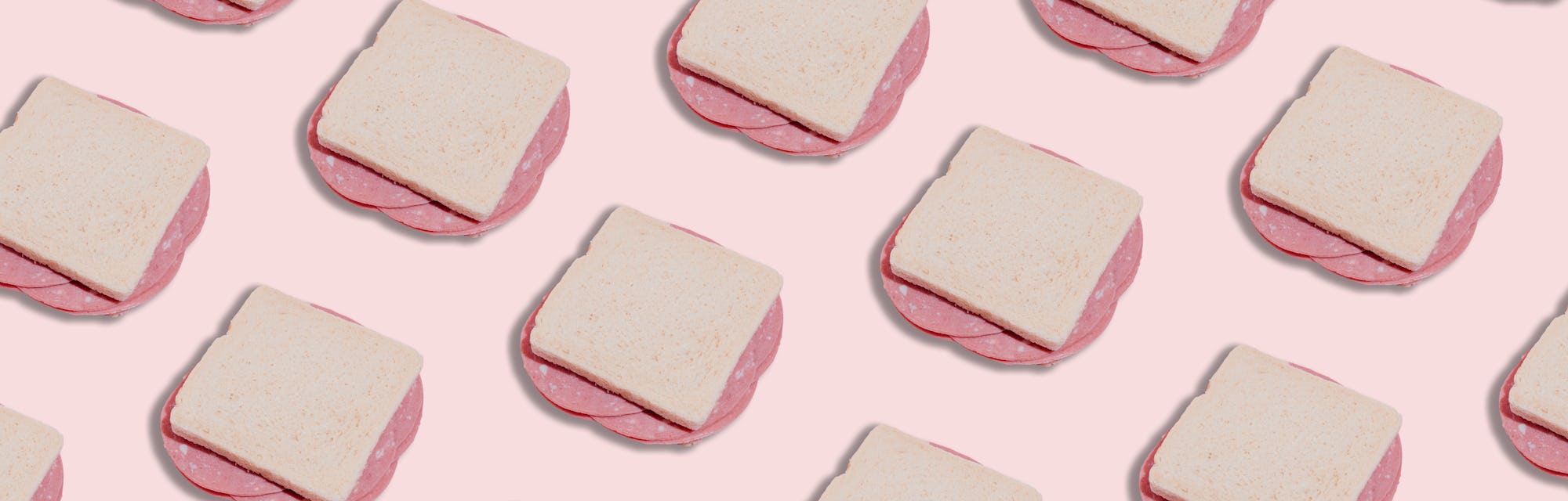 Pattern of a Bologna sandwich on pink background for article on why you can't eat deli meat during p...